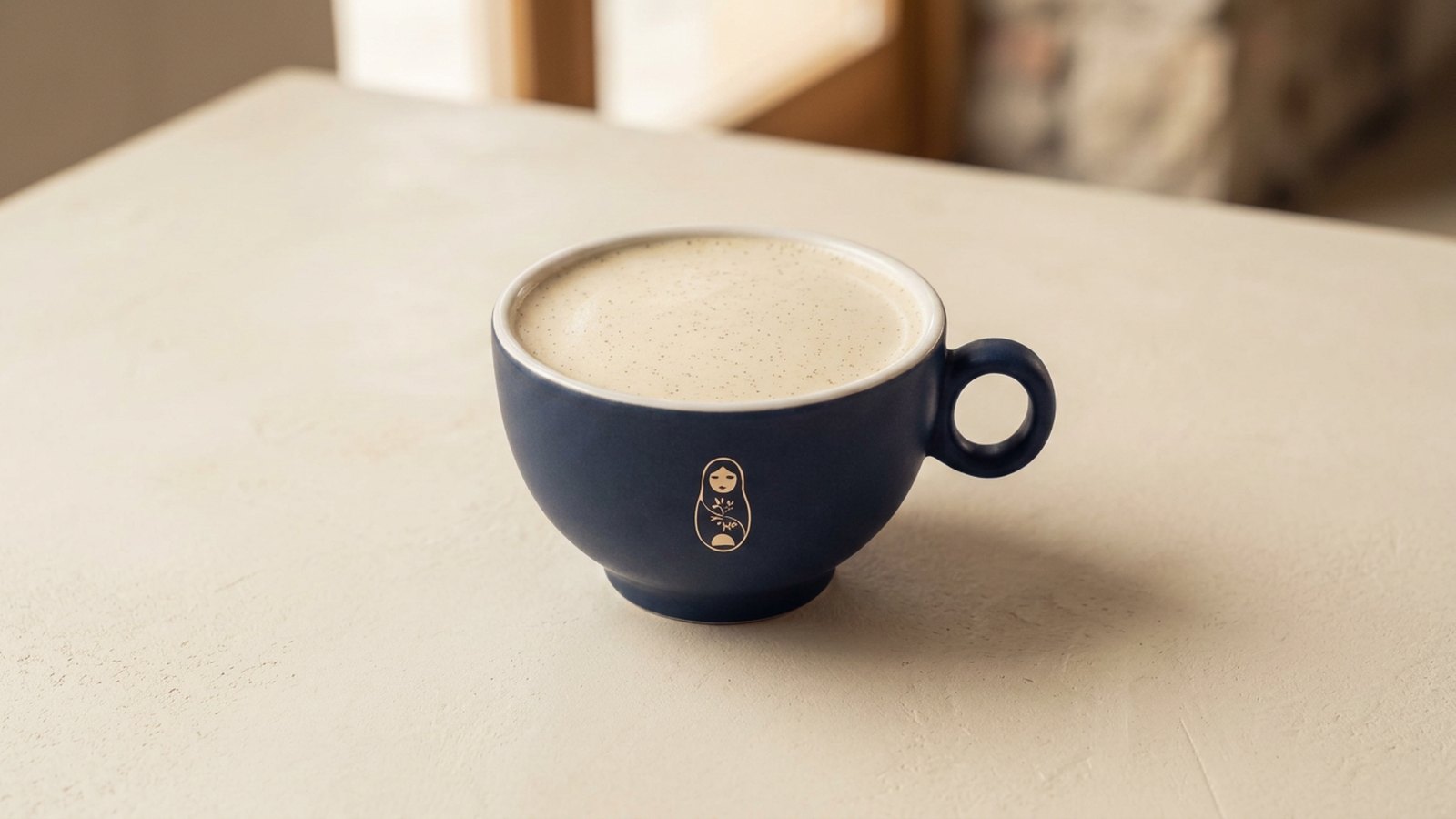 Raf coffee with vanilla cream foam in a matte navy ceramic cup and saucer at Krasivo Beauty Cafe